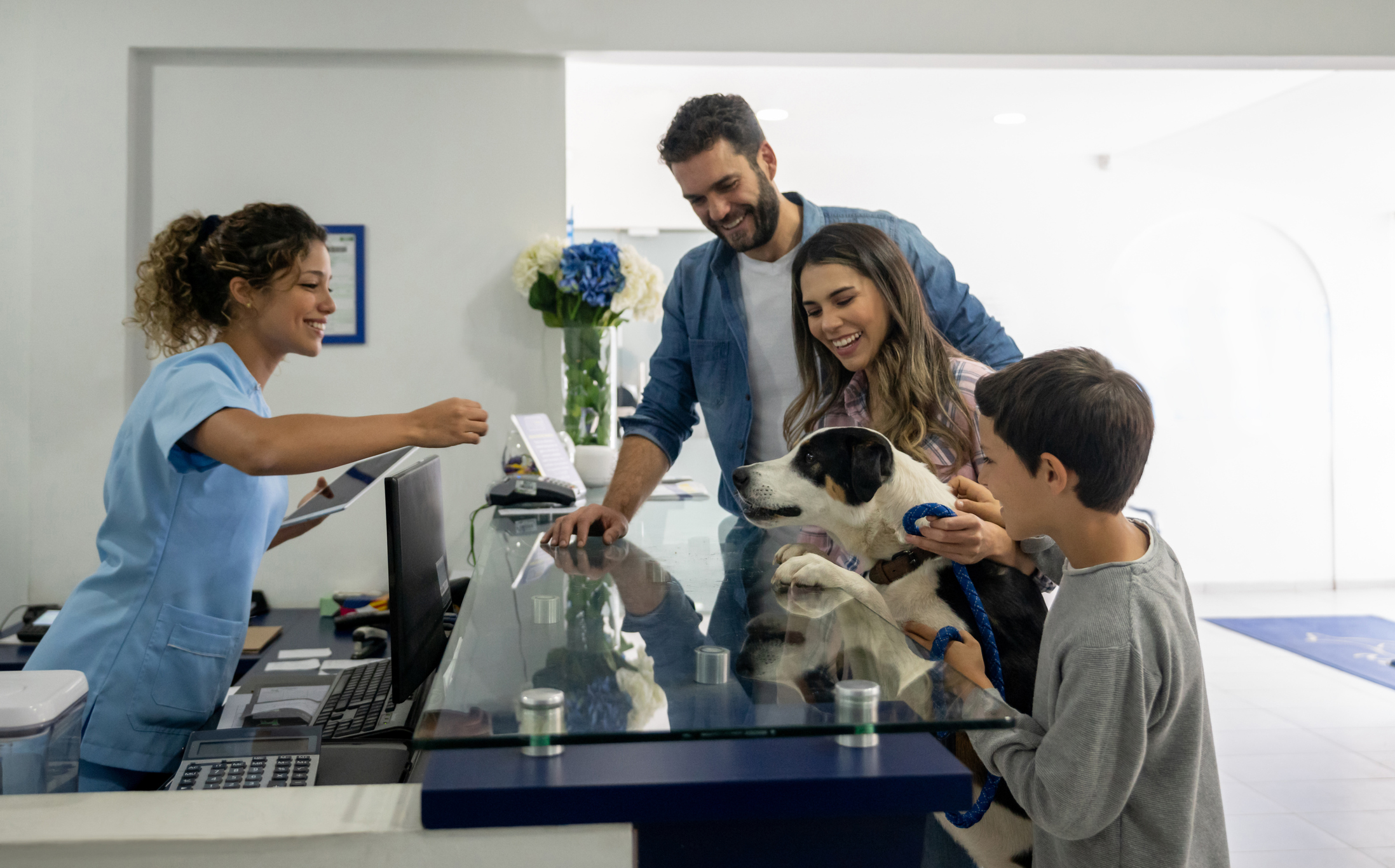 A family takes their dog to their vet.