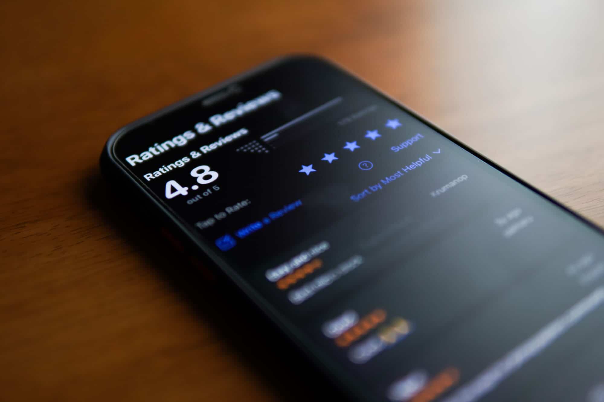 A smart phone with a list of ratings and reviews.