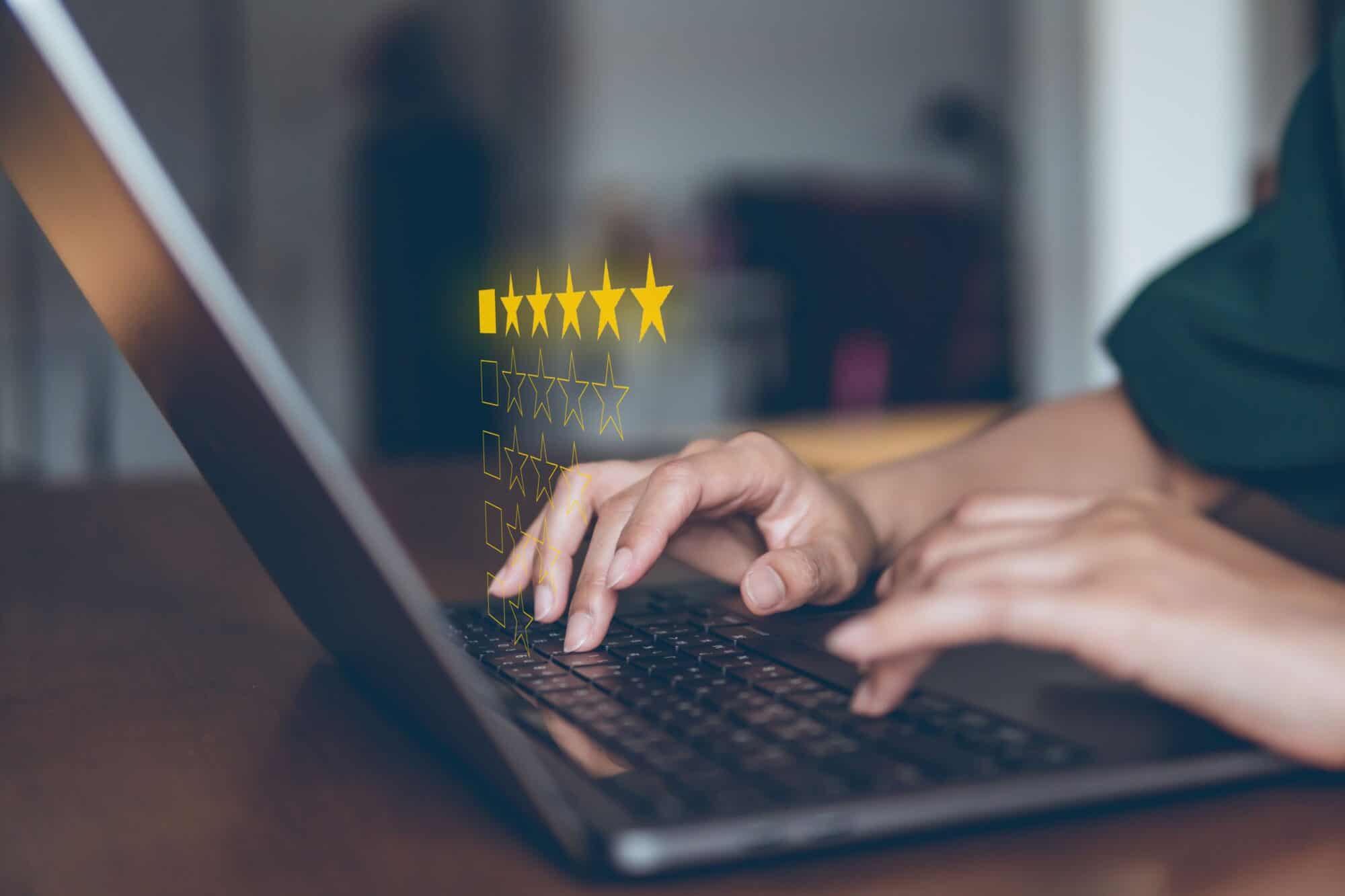 A closeup of a laptop and a 5-star review