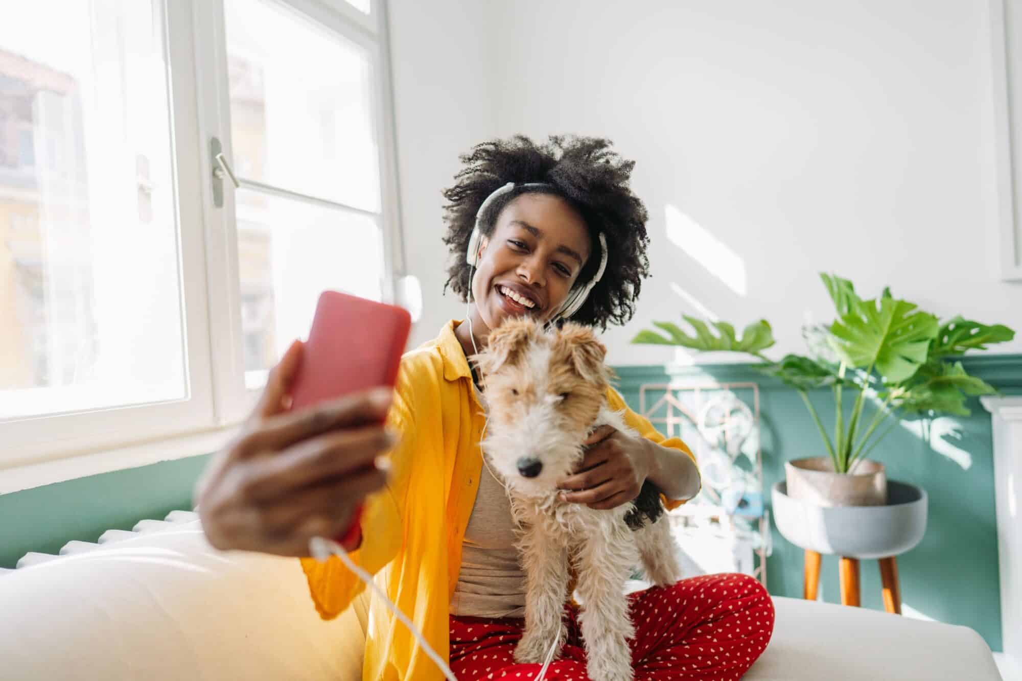 A woman taking a selfie with her dog.