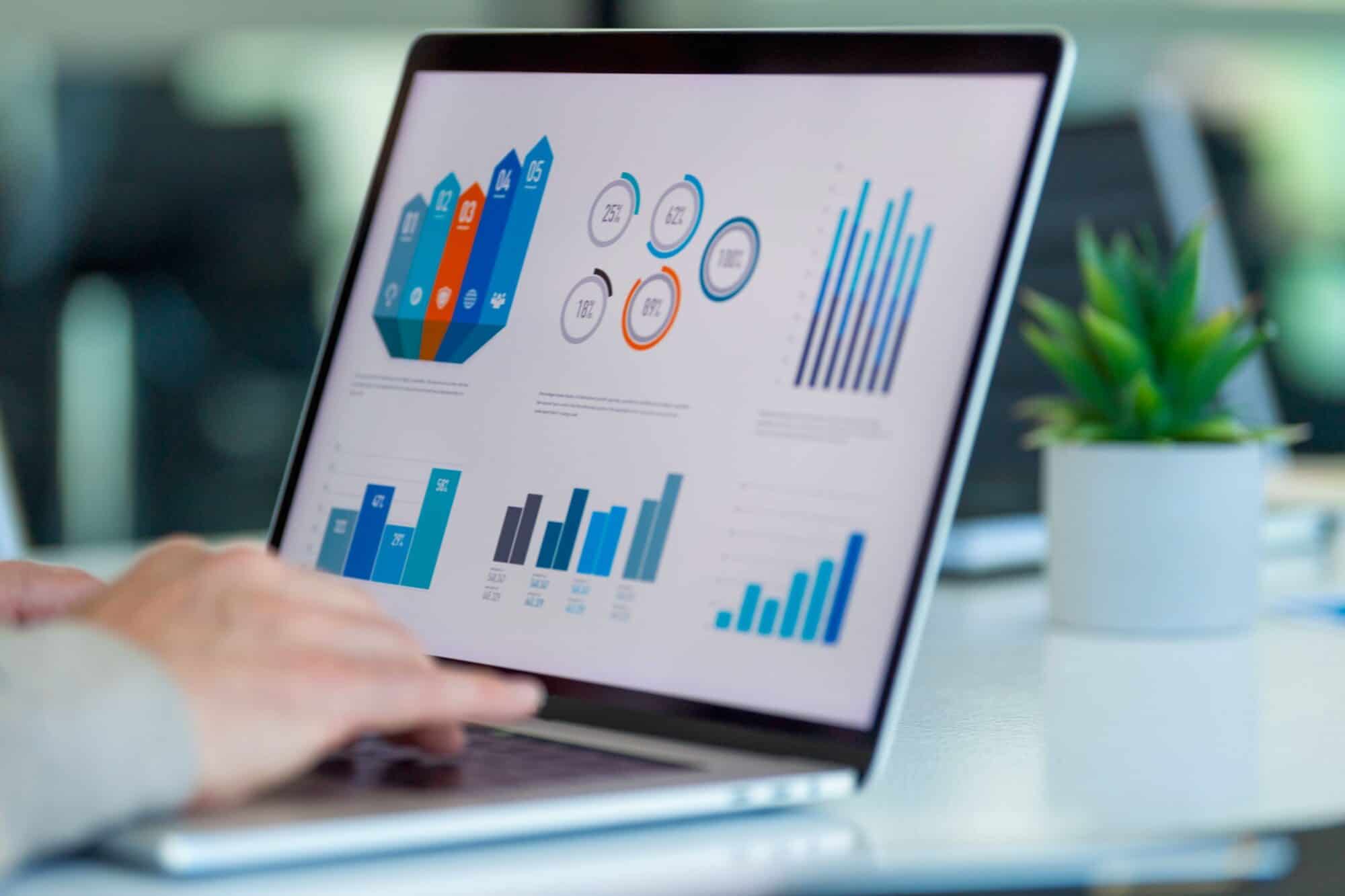 A person looking at a financial report on a laptop.