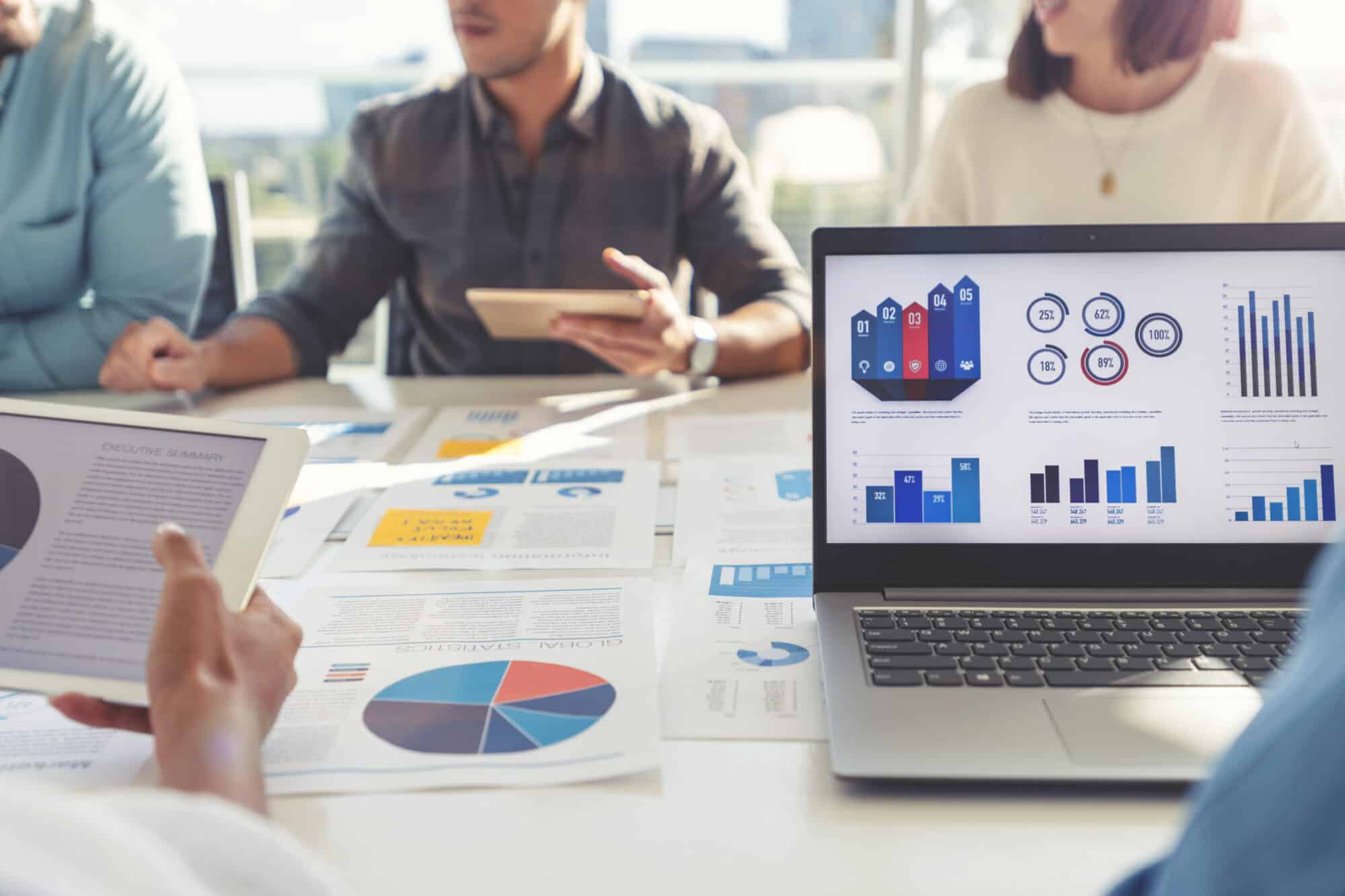 A group of people reviewing report metrics.