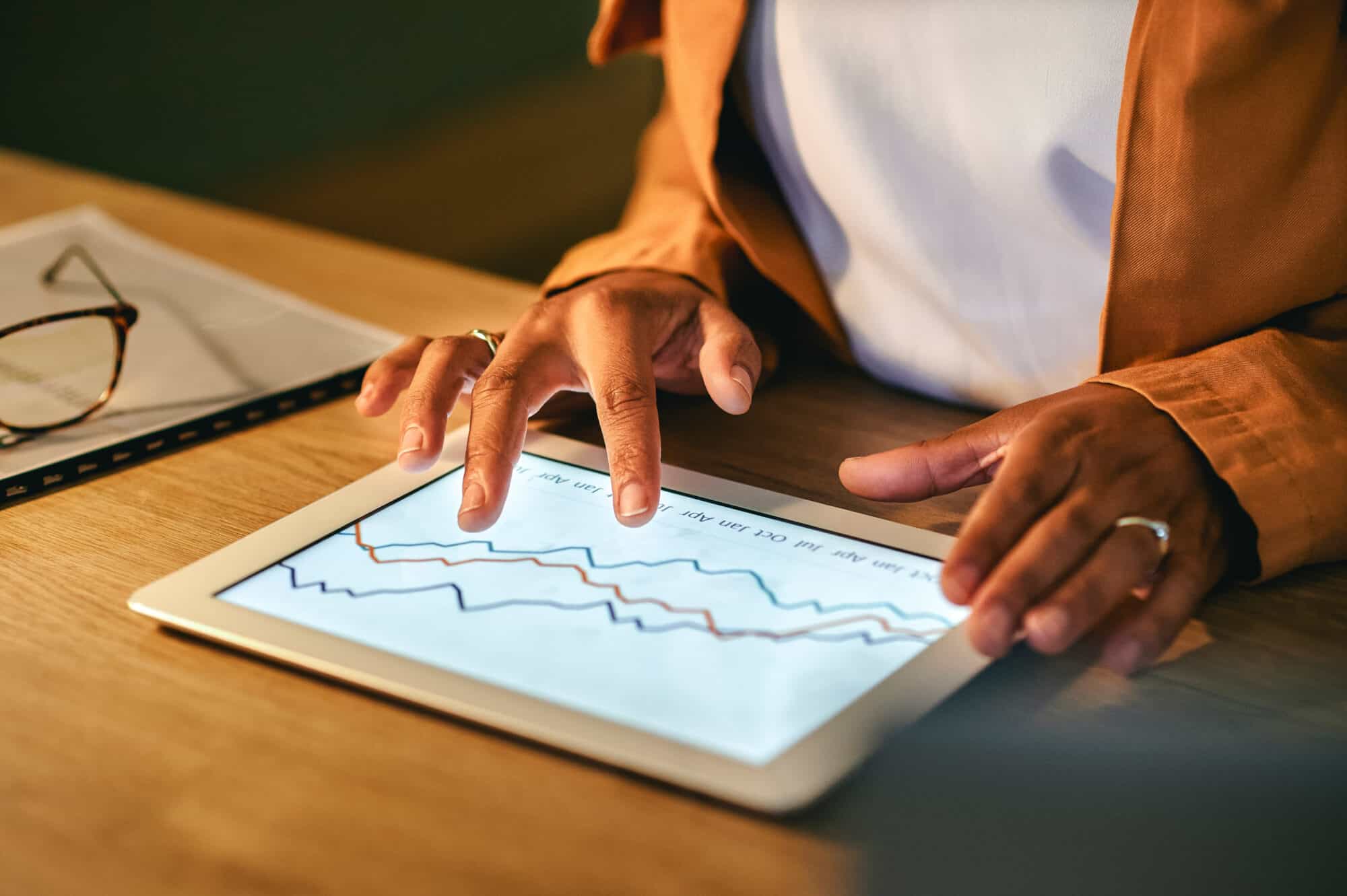 A woman looking at Google analytics on her tablet.