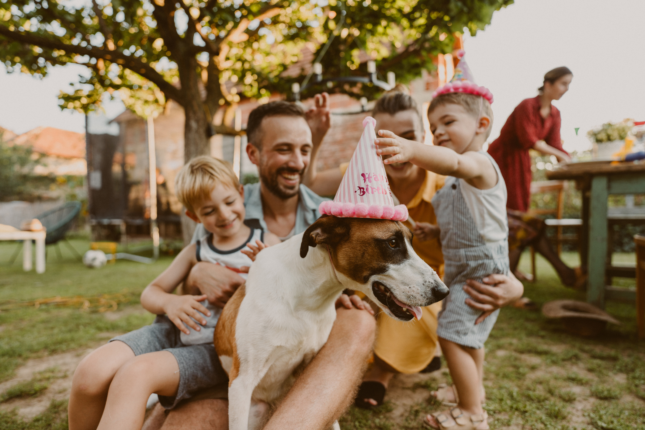 A family at a party with their dog.