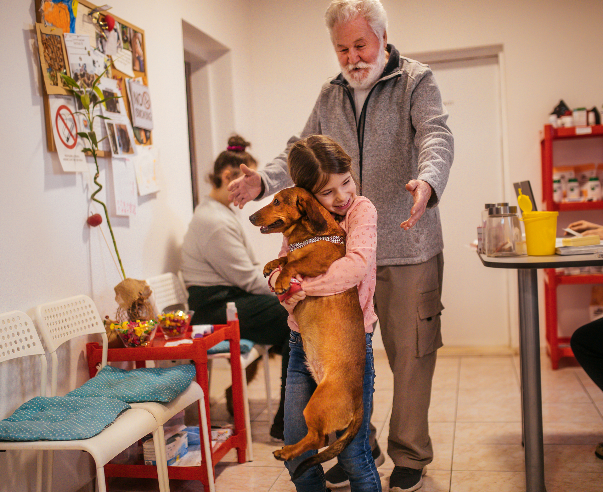 A girl and her dog at a local veterinary hospital.